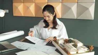 Genç, güzel mimar mühendisinin kalemle ölçüm yaptığı yere yakın çekim. İç mimar, tasarım evinin yapısını kalemle işaret ediyor. İş tasarımı konsepti. Geçmişi bulanıklaştırıyor. Yönlendirici.