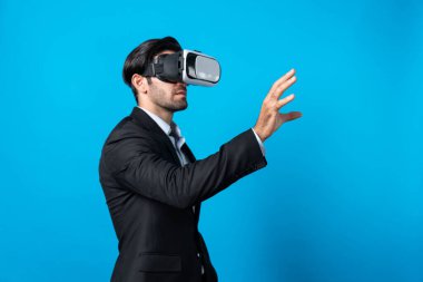 Profesyonel, zeki iş adamı, VR gözlük takarken elinde bir şey tutuyor. Sanal gerçeklik gözlüklü Kafkas proje yöneticisi mavi arka planlı mevcut teknoloji yeniliği. Sapma.