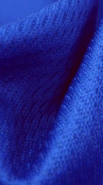 Parlak spandeks likra kumaşının detaylı kumaş dokusunu kapayın ve makro yakın plan çekimde doli ile akın edin. Dalgalı, temiz elastik dokuma malzemesi. Tekstil soyut arka planı. Kıyafet endüstrisi konsepti.