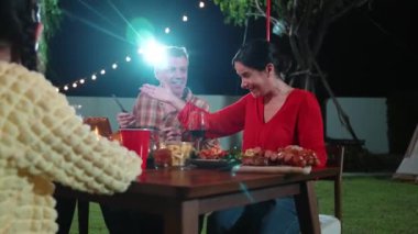 Family together for holiday celebration in garden. Family member gather have dinner. Outdoor picnic activity to relax with food and spend time with cute relatives cross generation gap. Divergence.