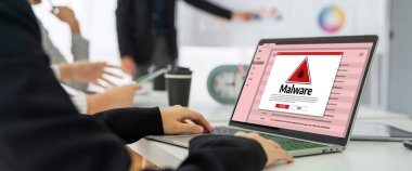 Cyber attacking concept. Malware alert showing on computer screen display scam and threat detection on computer system or online server to be removed snugly.
