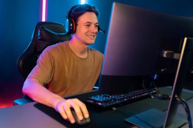 Kazanmak için çevrimiçi oyun oynayan akıllı flama makinesinin sunucu kanalı, neon ışıklı odada seçilen takım yarışması için izleyicilerle birlikte canlı yayında canlı yayında kulaklık takıyor. Bireysel.