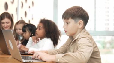Çocuk BTMM Teknoloji sınıfında çok kültürlü bir arkadaşla bilgisayar oyunu oynuyor. Mühendislik kodları ve bulanık geçmişi olan programlama sistemi üzerine çok kültürlü bir öğrenci çalışması. Etkinlik.