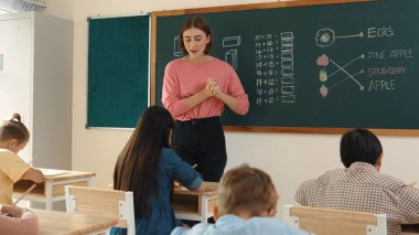 Zeki öğretmen sınıfta fikri açıklarken sevimli öğrenci ödevlerini kontrol ediyor. Not defterine bakıp matematik teorisinden çocuğa bahsederken sınıfta dolaşan çekici bir eğitmen. Pedagoji.