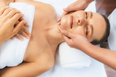 Kafkasyalı kadın stres önleyici kafa masajından ve lüks tatil beldesi ya da otel spa salonundaki modern ışık ortamında yüz güzelliği eğlencelerini şımartmaktan hoşlanıyor. Sessiz.