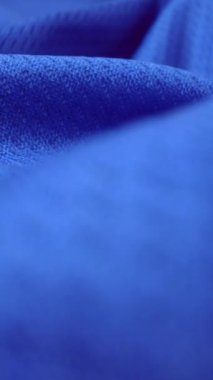 Parlak spandeks likra kumaşının detaylı kumaş dokusunu kapayın ve makro yakın plan çekimde doli ile akın edin. Dalgalı, temiz elastik dokuma malzemesi. Tekstil soyut arka planı. Kıyafet endüstrisi konsepti.