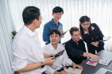 Bir grup farklı ofis çalışanı şirket ofis odasında stratejik iş pazarlama planlamasında birlikte çalışıyor. İş yeri konseptinde pozitif takım çalışması. Tedbirli