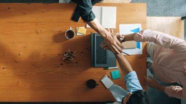 Başarılı bir projeyi kutlamak için el ele tutuşup el ele tutuşurken dizüstü bilgisayara bakan yetenekli iş adamlarının en iyi görüntüsü. Birliğin temsilcisi, takım çalışması birlikteliği. Cemaat.