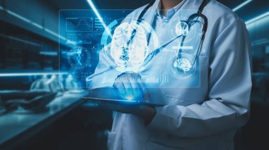 Laboratuvarda geçmişi bulanık bir şekilde duran beyin hologramıyla elinde tablet bulunan tıbbi işçilere yakın çekim. Doktor beyin araştırmalarında hasta semptomlarını kontrol ediyor. Teknoloji. İyileştirici.