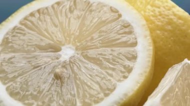 Bir dilim taze limon, parlak sarı ve canlı bir kalite, açıkta duruyor. Serinletici bir sıvıyla parlayan et, parçalanmış iç organlarını ortaya çıkarır. Turunçgillerin canlılığının özü. Geliştirilebilir.