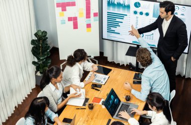 Toplantı masasındaki finansal veri raporlarını analiz eden çeşitli iş analist gruplarının geniş görüşü. İş zekası analizine göre çizelge ve grafik paneli. Çok titiz.