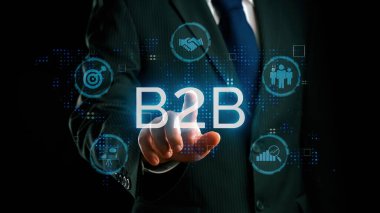 İş adamı B2B peyzajında geziniyor, iş-iş bağlantılarını geliştirmek için kullanım teknolojisi kullanıyor. B2B etkileşimini yeniden şekillendiren keşifler, iş-iş stratejilerinde yenilikleri yönlendiren araçlar. Kullanıcı Kimliği