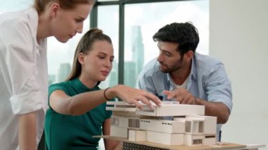 Uzman mimar mühendis takımı ev inşaatı ve ölçü uzunluğu hakkında tartışıyor. İç mimar grubu birlikte çalışıyor, beyin fırtınası yapıyor, bina tasarımı fikrini paylaşıyor. İzleme