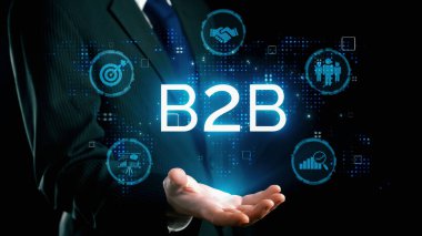 İş adamı B2B peyzajında geziniyor, iş-iş bağlantılarını geliştirmek için kullanım teknolojisi kullanıyor. B2B etkileşimini yeniden şekillendiren keşifler, iş-iş stratejilerinde yenilikleri yönlendiren araçlar. Kullanıcı Kimliği