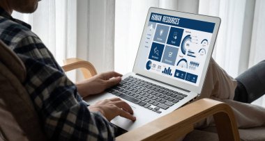 Human resources management software on computer screen helping human resources employee to manage recruitment, payroll, staff searching and KPI evaluation snugly
