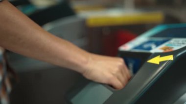 Çok kültürlü yolcuların elleri turnikelere madeni para koydu ve içeri girmek için gökyüzü treni, metro gibi insanlarla çevrili toplu taşıma araçlarını kullandı. Çalışma rutini. Sevinçli..