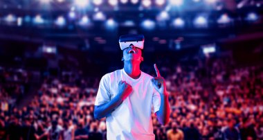 Afrikalı oyuncu, VR kulaklığı takıp, müfettişin tezahüratı ve desteğiyle arenada dururken oyunu heyecanlandırdı. Büyülü teknoloji kullanarak metaevrene erişen çekici bir insan. Yenilik. Yaratıcılık.