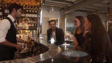 Gece kulübündeki lüks gece kulübünde, içki tezgahında çalışan akıllı barmen servisinde çift ya da arkadaş grubuyla gülen VIP müşterilere özel cin kokteyli servisi. Vinosity.