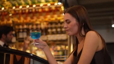 Oturan güzel bayan misafirin canı sıkılıyor. Arkadaşlarını beklemekten ya da barmenlerin arka planındaki lüks tezgah barında karışık votka içmekten sıkılıyor. Vinosity.