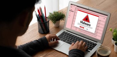 Cyber attacking concept. Malware alert showing on computer screen display scam and threat detection on computer system or online server to be removed snugly.