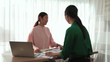 Yavaş çekim iki tasarımcı beyin fırtınası yapıyor ve grafik tasarımı için renk seçiyor ya da istemci renk bozukluklarını tasarımcı bürosundaki kromatik konsültasyonla karşılaştırıyor. Değiştirilmiş