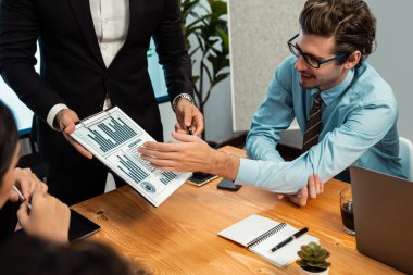 Ofis masasındaki finansal veri raporlarını analiz eden çeşitli bir grup iş analisti. Stratejik pazarlama planlaması için iş istihbarat analizine göre grafikler ve grafikler.