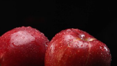 A fresh red apples, showcasing its crisp and white flesh, rests dramatically against a stark black background. The smooth, apple-crisp surface, Apple slice with separated black background. Comestible. clipart