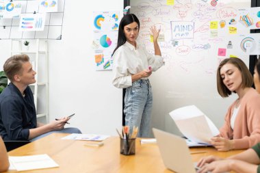 Genç ve güzel lider pazarlama stratejisini sunarken, uzman yatırımcı ve proje yöneticisi de yeni başlayan iş toplantısında iş performansını analiz etmeye çalışıyor. Çok ırklı bir grup. Tertemiz..