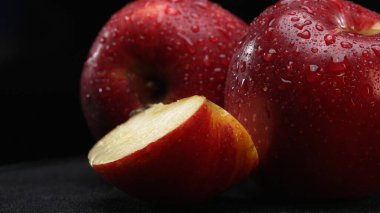 A slice of apple, showcasing its crisp and white flesh, rests dramatically against a stark black background. The smooth, apple-crisp surface, Apple slice with separated black background. Comestible. clipart