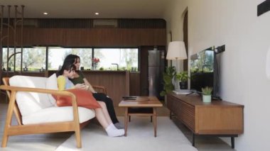 Büyükanne ve torun birlikte TV 'de ilginç eğlence medyası izliyorlar. Eski üst düzey kullanım teknolojisi, genç nesil çapraz nesil ile iletişim kurarak aile bağlarını güçlendiriyor. Uyumsuzluk.