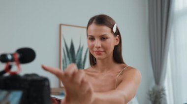 Genç kadın canlı yayına başlıyor. Sosyal medya için güzellik ve kozmetik video içeriği. Güzellik blogcusu kameraya gülümserken seyircilere ve takipçilere güzellik bakımını gösteriyor. Düzenle