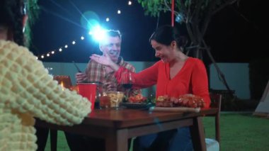 Family together for holiday celebration in garden. Family member gather have dinner. Outdoor picnic activity to relax with food and spend time with cute relatives cross generation gap. Divergence.