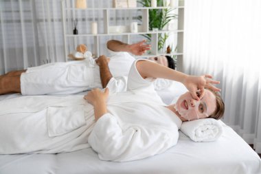 Kaplıca salonunun sakin, modern gündüz atmosferi, birkaç müşteri yüz maskesi takarak kendini yenilemeye çalışıyor. Yüz bakımı ve güzellik kozmetolojisi prosedürü. Sessiz.