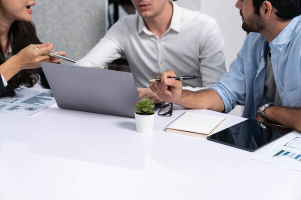 Diverse corporate audit team or company bookkeeper and accountant consultant calculate account expenses and income budget for tax refunds using calculators in busy workspace. Prudent