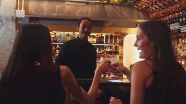 Barda oturmuş, Margarita kokteylinin tadını çıkartan ekşi bir içkinin tadını çıkaran bir çiftle sohbet ederken, kadınlar lüks tezgahın önünde, canlı bir gece kulübünde arkadaşlarını bekliyorlar. Vinosity.