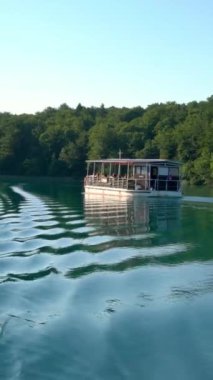 Turistler Hırvatistan 'ın Plitvice Gölleri' nde tekneyle seyahat ediyorlar. Plitvice Lakes Ulusal Parkı, Hırvatistan 'ın orta kesimindeki Karst Dağı' ndaki UNESCO Dünya Mirası..
