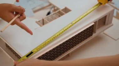 Mimari ekipman incelemesi kullanarak yavaş çekim ev tasarımcısı ve müşteri veya müşteriyle birlikte mimari ev modeli tasarım örneklerini ölçer. Filizlenen