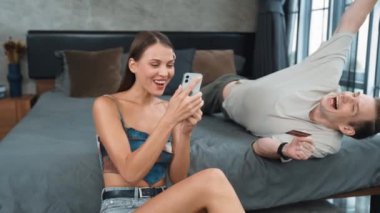 Genç çift, online ödeme uygulaması ve dijital cüzdanı kullanarak kredi kartıyla ödeme yaptıktan sonra mutlu ve heyecanlı hissediyorlar. Mobil internet üzerinden alışveriş ve modern alımlar. Düzenle