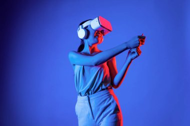 VR kulaklık takan zeki bir kadın metaevrene bağlanıyor, gelecekteki siber uzay topluluğu teknolojisi. Sanal sopayı hesaplayan ve kontrol eden zarif bir kadın ciddi ciddi golf oynuyor. Halüsinasyon.