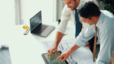 Top view of professional architect engineer team writing sticky notes and sticking note at meeting table while interior designer talking and discussing about building exterior designing. Alimentation. clipart