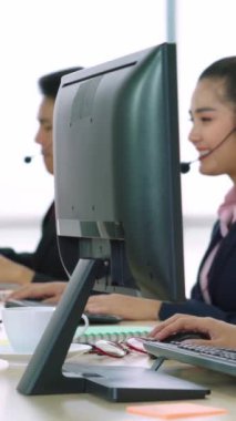 Ofiste çalışan kulaklık takan işadamları uzak müşteri ya da meslektaşlarını desteklemek için çalışıyorlar. Arama merkezi, tele pazarlama, müşteri destek acentesi telefon görüşmesinde hizmet sunar.