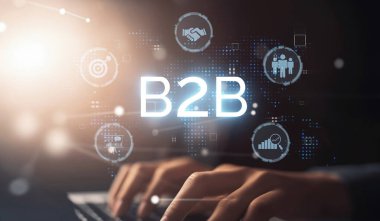 İş adamı B2B peyzajında geziniyor, iş-iş bağlantılarını geliştirmek için kullanım teknolojisi kullanıyor. B2B etkileşimlerini yeniden şekillendirir, iş stratejilerindeki yenilikleri tetikler. EIDE