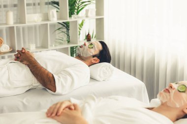 Kaplıca salonunun sakin atmosferi, birkaç müşteri lüks salatalık yüz maskesi takarak kendini yenilemeye çalışıyor. Yüz bakımı tedavisi ve güzellik konsepti. Sessiz.