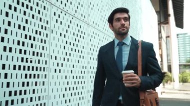 İş adamı telefona cevap verir ve iş yatırımları hakkında konuşur. İş planı, pazarlama stratejisi ya da çalışma hakkında konuşmak için akıllı telefonla konuşurken sokakta yürüyen mutlu bir yönetici. Sevinçli..