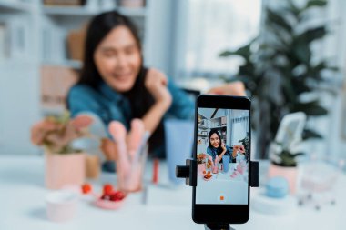 Kozmetik makyaj makyajı, ruj, pastel renkler, sosyal medyada kol testi promosyonunda en çok satan kitaplar koleksiyonunu gösteren seçici odaklı telefon. Taktik.