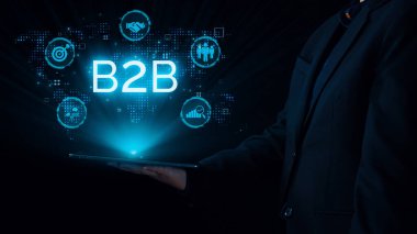 İş adamı B2B peyzajında geziniyor, iş-iş bağlantılarını geliştirmek için kullanım teknolojisi kullanıyor. B2B etkileşimini yeniden şekillendiren keşifler, iş-iş stratejilerinde yenilikleri yönlendiren araçlar. Kullanıcı Kimliği