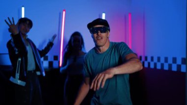 Kameranın önünde dans eden yetenekli break dansçı farklı arkadaşları pop ya da hip hop müziği dinlemek için arkada dans ediyor. Çekici performans ekibi kameraya doğru hareketli hareketler sergiliyor. Mutluluk.