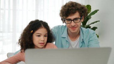 Father explain generate AI while american girl looking at screen. Attractive caucasian dad teaching daughter learning coding engineering prompt and programing system at table with headphone. Pedagogy. clipart