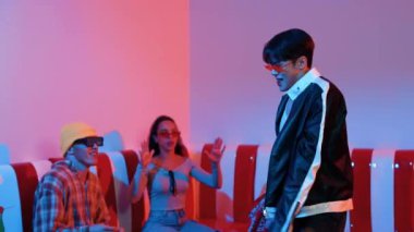 Asyalı bir adam pop müzikle dans ederken, çok kültürlü bir arkadaş evde ışık altında oturuyor. Çekici bir sokak dansçısı kameraya bakarken hip hop müzik dinliyor. Mutluluk.
