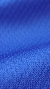 Parlak spandeks likra kumaşının detaylı kumaş dokusunu kapayın ve makro yakın plan çekimde doli ile akın edin. Dalgalı, temiz elastik dokuma malzemesi. Tekstil soyut arka planı. Kıyafet endüstrisi konsepti.